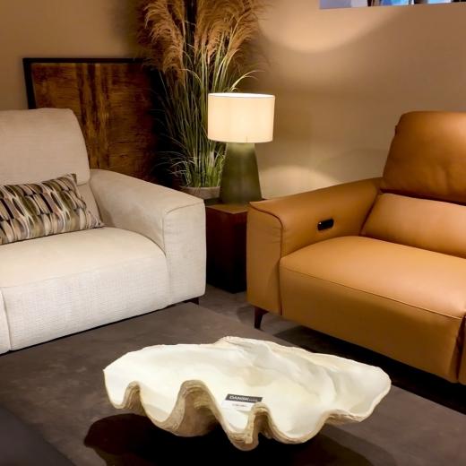 Warm tan and soft cream, styled for an inviting living space. With reclining comfort, complimentary t...