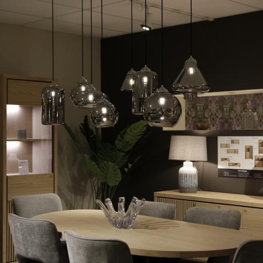 Understated design, elevated by the details. A beautifully crafted table, set beneath soft hanging li...